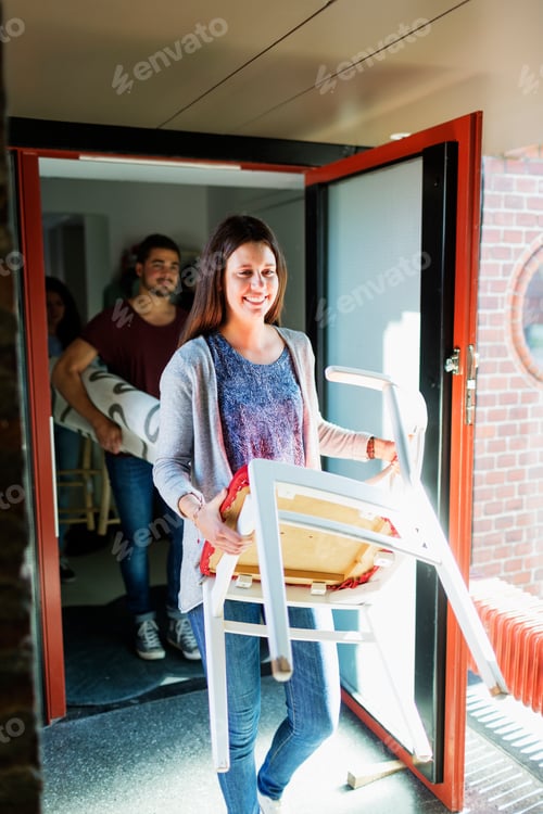 Preview: Young friends moving furniture in new home