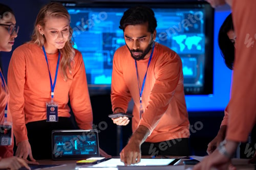 Preview: team of app developers in uniform presents their new software on smartphones.