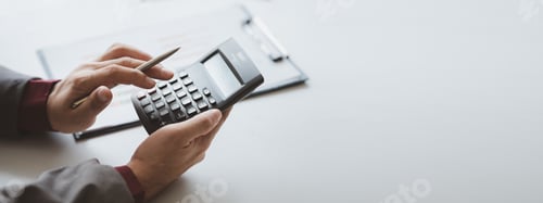 Preview: Businessman using a calculator to calculate numbers on a company's financial documents, he is analyz