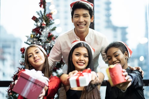 Preview: Group of various nationalities friends or colleagues having Christmas party in working office.