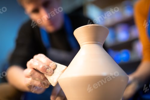 Preview: Working process of man's work at potters wheel in art studio
