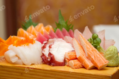 Preview: Sashimi (japanese food). Sliced raw seafood on wooden plate.