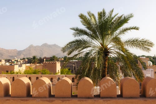 Preview: View of Nizwa Fort walls with cold town in background in Nizwa, Oman