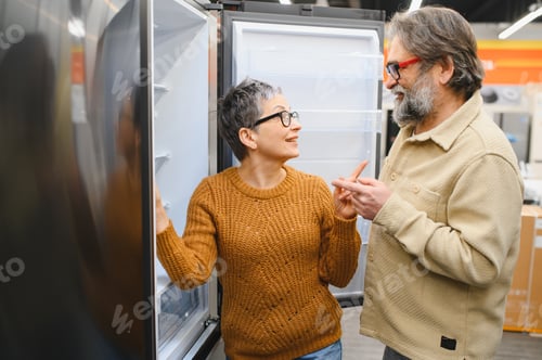 Preview: Senior couple choosing new refrigerator in appliance store