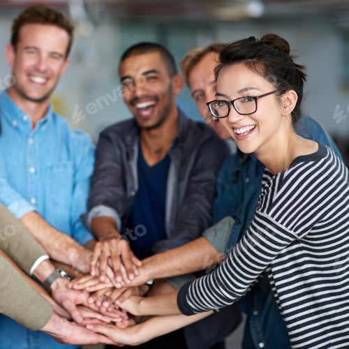 Preview: We did it together. Happy staff group celebrating unity with their hands all together.