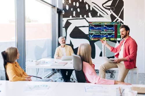 Preview: Business team analyzing stock market data during meeting
