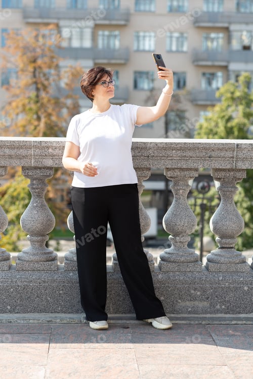 Preview: Woman Taking a Selfie on a Bridge