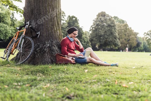 Preview: Man using laptop in park