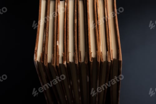 Preview: Pile of handmade notebooks isolated against black background