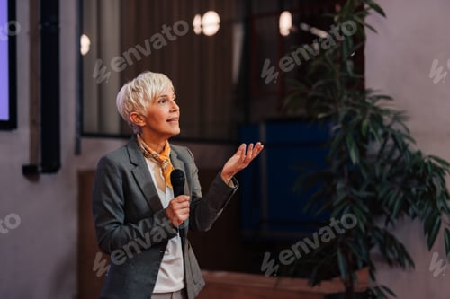 Preview: Focused senior businesswoman giving the lecture to the young business people.