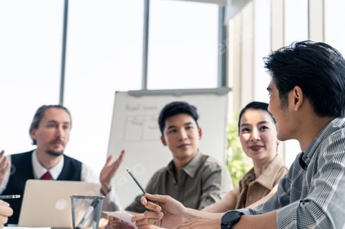 Preview: Asian man and team working brainstorm to solve problem and presentation new idea in office