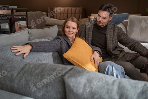 Preview: Young Caucasian couple shopping for new couch