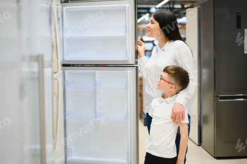 Preview: family uying domestic refrigerator in supermarket