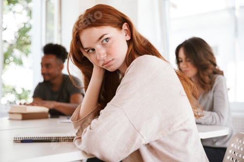 Preview: Tired young redhead lady looking aside