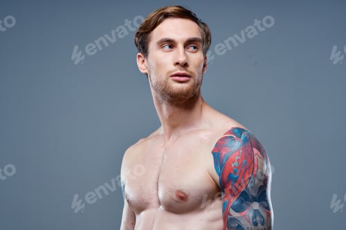 Preview: man with tattoo naked torso sport fitness gray background portrait