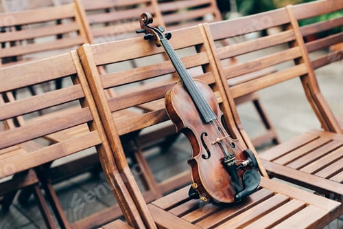Preview: Shot of violin on wooden chair, with no people. Classic music and art concept