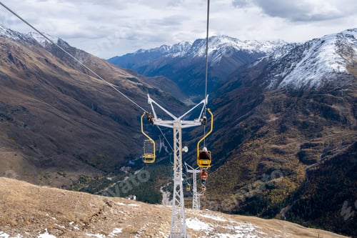 Preview: Mountain landscape with chairs of a single-seat cable car