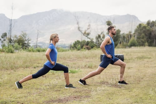 Preview: Fit man and woman exercising in boot camp