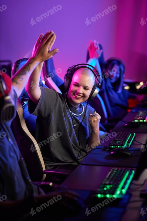 Preview: Woman Playing Video Games Professionally High Five with Teammate