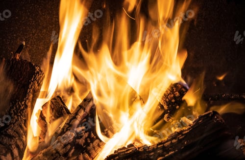 Preview: Fire orange tongues on black background in a brick fireplace