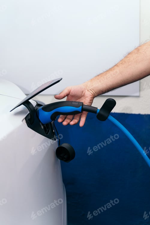 Preview: Open Hand of Unrecognizable Person with Electric Car Charger