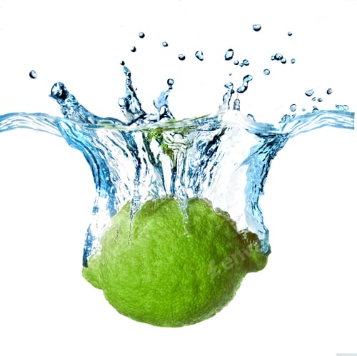 Preview: Fresh lime dropped into water with splash isolated on white