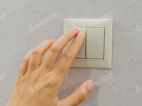 Preview: save energy - switch off. Close up of finger is turning on or off on light switch. Copy space.