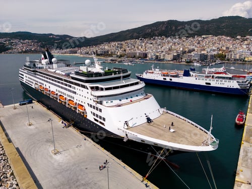 Preview: Taking in the stunning aerial view, a massive cruise ship sits docked in the bustling port
