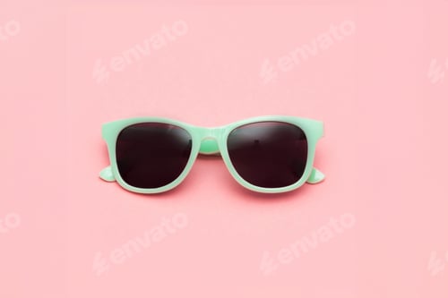 Preview: Mint sunglasses isolated on pink background. Closeup.