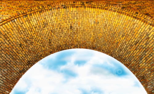 Preview: Low angle shot of a brick arch and cloudy sky