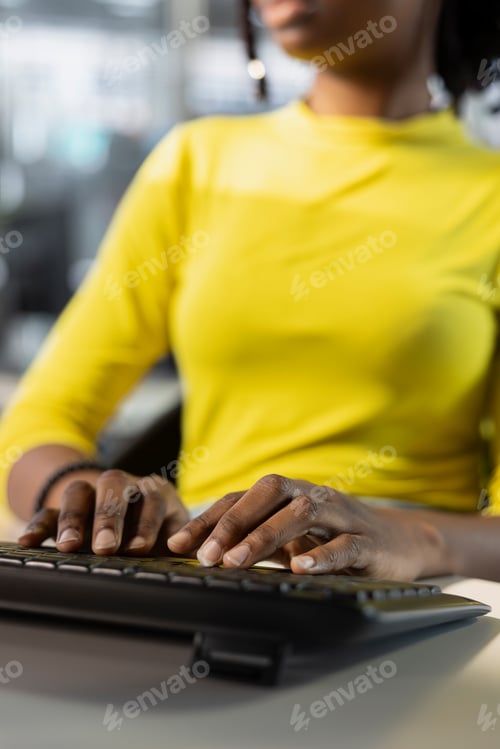 Preview: Meticulous accountant imputing revenue figures on computer in office
