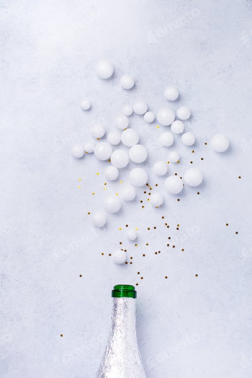 Preview: Christmas champagne bottle with sprinkles white color on white background. New year concept. Top vie