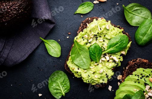 Preview: Avocado toast with rye bread with spinach, crushed cashew nuts and sesame seeds