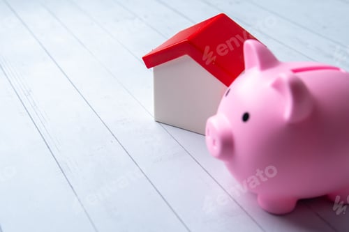 Preview: A pink piggy bank and a toy house.