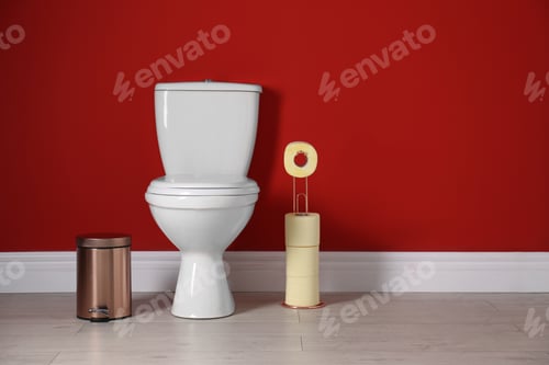 Preview: Toilet bowl with paper rolls and trash bin in restroom. Space for text