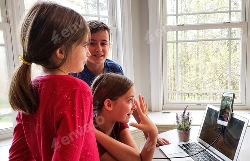 Preview: Candid moments at desk with natural light through a window visiting with grandparents.