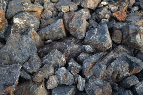 Preview: the rocks are covered in small black rocks on the ground