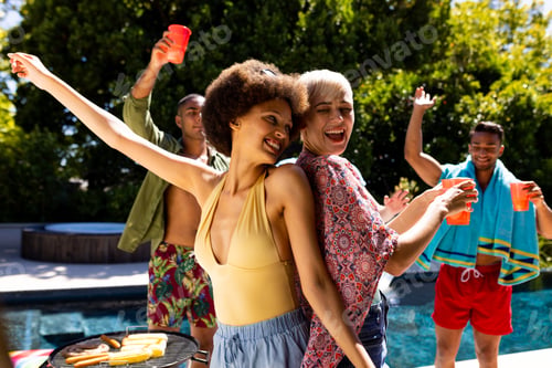 Preview: Happy diverse group of friends having pool party, barbecuing and dancing in garden