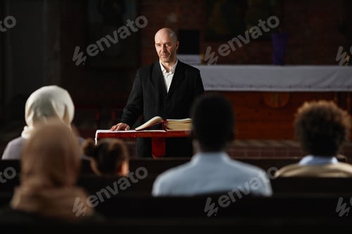 Preview: Preacher reading prayer for people in church