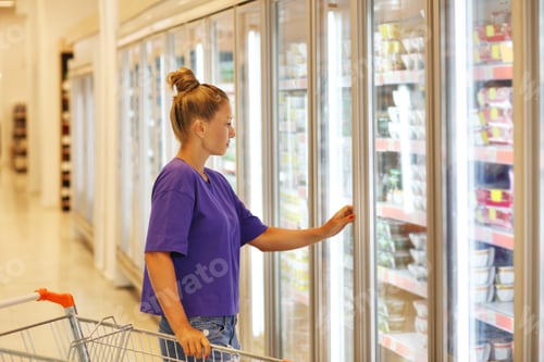 Preview: Woman Choosing Frozen Food From A Supermarket Freezer