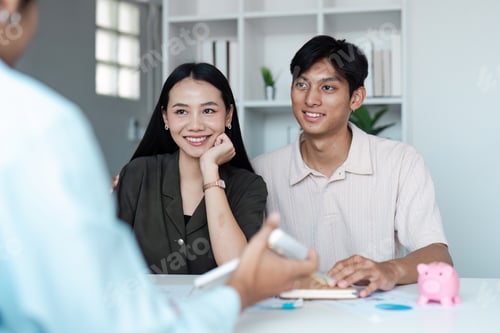 Preview: Young Couple Discussing Savings Plans with Financial Advisor in Modern Office Setting