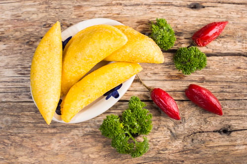 Preview: Empanadas and hot pepper on wooden background, traditional Colombian food