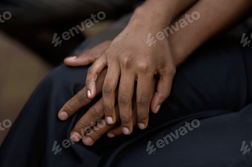 Preview: a black couple in love hold each other hand, symbol of support trust and empathy