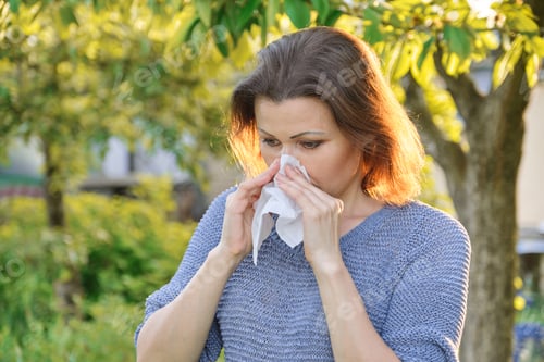 Preview: Seasonal allergies, woman with nasal wipe, sneezing, wiping nose outdoor