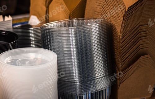 Preview: Stacks of paper and plastic take out disposable containers on a restaurant shelf