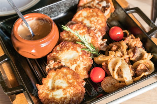 Potato Pancakes with Fried Onions and Creamy Sauce