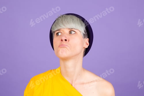 Preview: Stylish european woman on purple background sad upset unhappy emotions