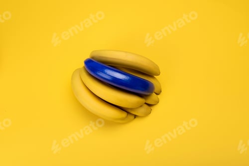 Preview: Top view of blue and yellow bananas isolated on yellow, bunch of bananas