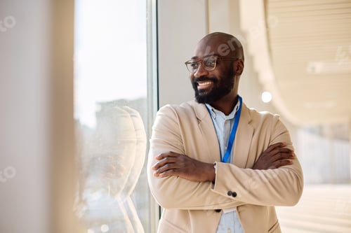 Preview: Successful black businessman in the office looking away.