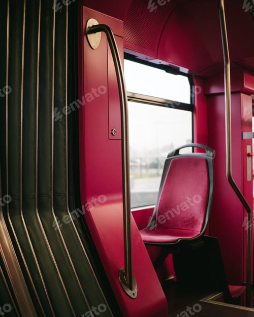 Vista previa: Vertical shot of a red empty seat on a bus
